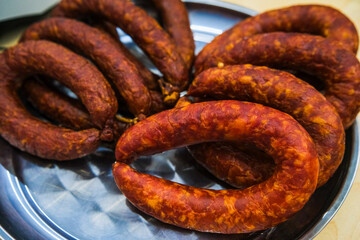 A showcase with various types of sausage and meat products.