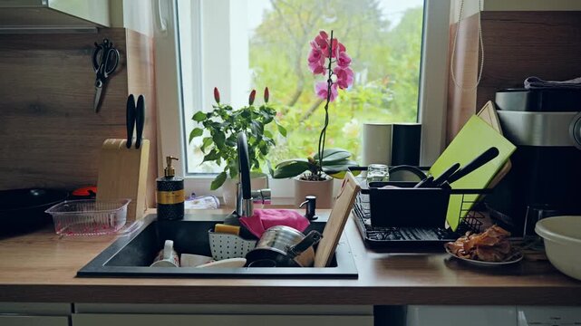Home kitchen, unwashed dishes near window symbolizing everyday domestic realism