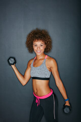 Obraz premium Exercise, dumbbells and portrait of happy woman in studio for fitness, strength training and bodybuilding. Space, workout and person with weights for muscles, strong arms or health on gray background