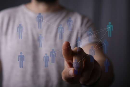 Close up of person touching digital network interface, people icons connected, representing social connections - Powered by Adobe