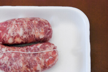 fresh italian sausages on foam tray