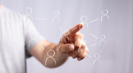 Hand interacting with a digital network of interconnected people icons, symbolizing global communication, social media, teamwork, and business c