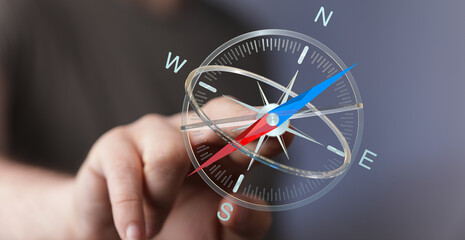 Close up shot of a hand touching a digital compass, direction and orientation concept, navigating the way, choice decision and guidan