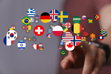 Conceptual image of hand touching floating flags, symbolizing globalization, communication, and interconnectedness. Represents global community,