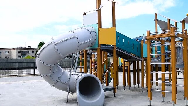 Playground with slides and swings on the background of an apartment building
