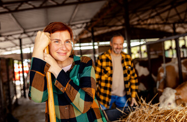 Portrait of female farmer in cow farm.