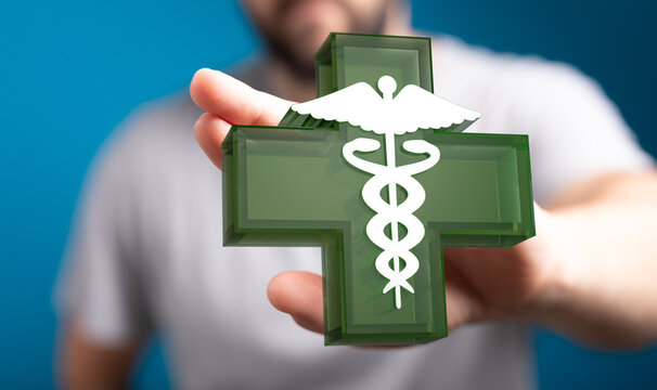 Close-up of a person holding a medical cross symbol. Ideal for healthcare, medicine, and wellness related them