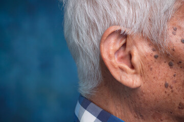 Side view of elderly ear and aging skin texture.