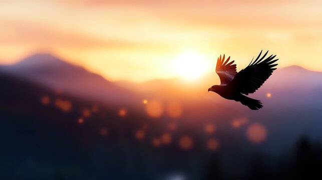 Majestic eagle soaring through golden sunset sky over mountain landscape with warm glowing light and bokeh effects creating inspirational freedom concept.