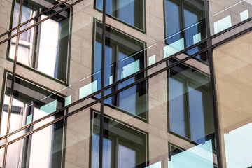 Modern architecture office shows glass facade with reflection on windows grid and corporate geometry for clean abstract business background