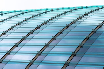Modern architecture roof canopy in glass curve with blue lines creates abstract pattern for corporate design background and innovation themes