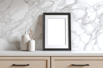 Blank picture frame mockup rests on a wooden cabinet surface against a white marble wall