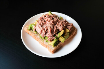 Tuna sandwich with avocado on wholemeal bread for breakfast.