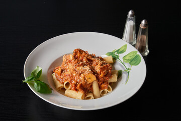 A plate of Italian Bolognese penne pasta au gratin