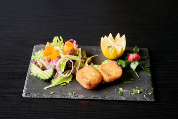 A plate of cheese or shrimp croquettes and salad