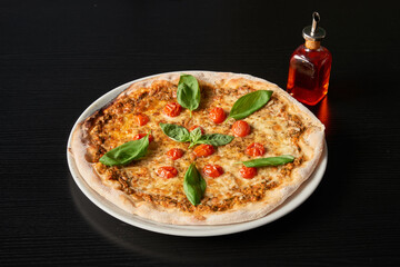 A plate of Margherita pizza and basil