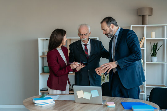Senior Businessman with Son and Daughter in Modern Office &ndash; Family Business Transition