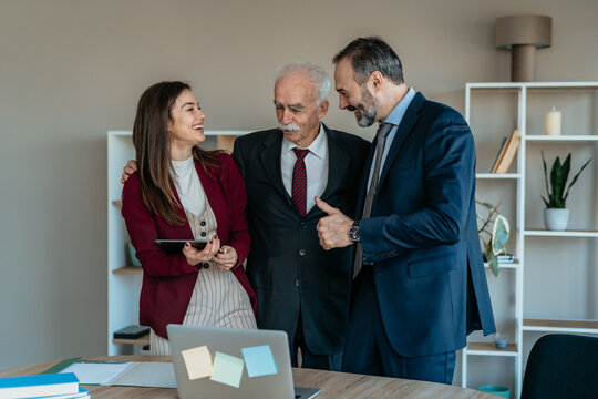Senior Businessman with Son and Daughter in Modern Office &ndash; Family Business Transition