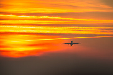 Airplane takeoff at sunset