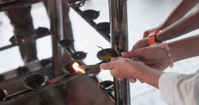 Pilgrims Lighting Oil Lamps During Prayer at the Temple of the Sacred Tooth Relic (Sri Dalada Maligawa), Kandy, Sri Lanka