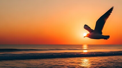 Seagull flying over ocean waves during golden sunset with warm orange sky reflecting on water surface creating peaceful coastal scene.