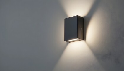 Modern wall light fixture with warm glow on gray wall