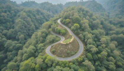 Aerial view of road in the middle of forest.Road curve construction up to mountain.Healthy environment concept and rainforest ecosystem.     




