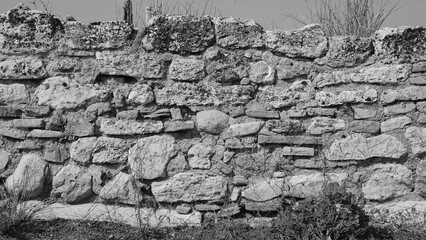 Stone Wall Weathered Texture Closeup. Black White Monochrome Landscape Pattern