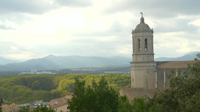 Historic Girona Skyline Featuring Cathedral Tower and Green Hills of Catalonia in Background