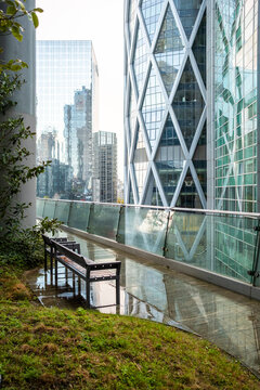 Quiet modern office rooftop garden with bench and greenery in La Defense Paris France offering empty corporate terrace space for rest