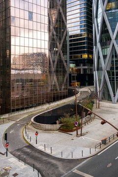 Empty modern office street with skyscraper architecture reflection in La Defense Paris France quiet corporate district after soft rain