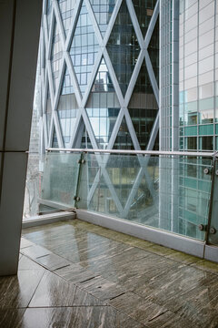 Wet empty modern terrace with glass window and architecture in La Defense Paris France capturing quiet office exterior after rainfall