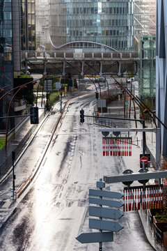 Rainy empty urban road intersection with pavement reflection in La Defense Paris France showing modern office district streets with no traffic