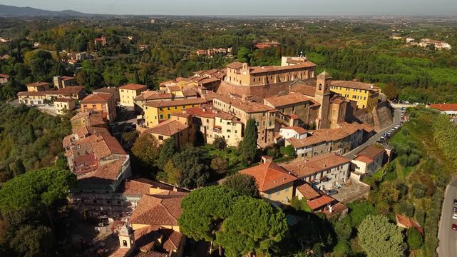 Panoramic Aerial View of Castello dei Vicari in Lari &mdash; Medieval Hillside Town in Tuscany with Orange Autumn Foliage and Scenic Tuscan Hills Landscape, Italy