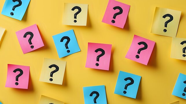 Colorful sticky notes with question marks scattered on yellow background for brainstorming, problem solving and decision making concepts in business presentations.