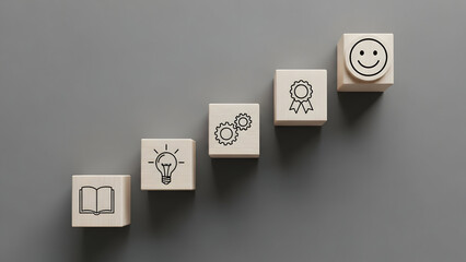 Conceptual image of wooden blocks displaying icons representing learning, ideas, processes, achievements and happiness, perfect for business promotion.