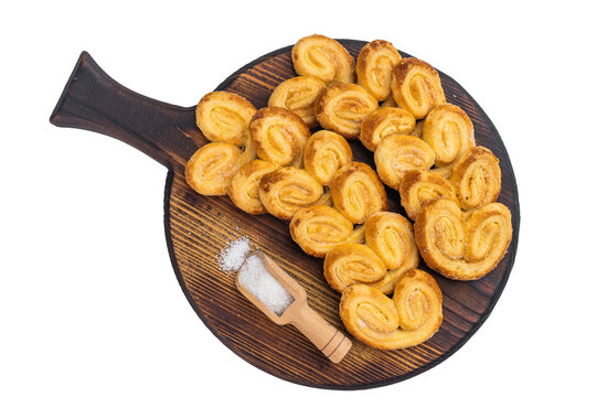 Homemade palmier pastry cookies on wooden board with sugar light isolated background bakery snack overhead with copy space