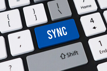Sync button on computer keyboard. Concept of data synchronization, cloud computing and device connectivity.