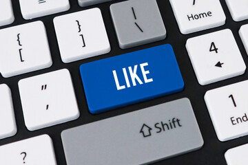 Like button on computer keyboard. Concept of social media engagement, digital approval and online popularity.