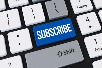 Subscribe button on computer keyboard. Concept of digital membership, content following and online newsletter.