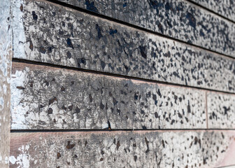 Extensive smoke damage on the exterior wall of a residential building after a fire incident in a suburban area