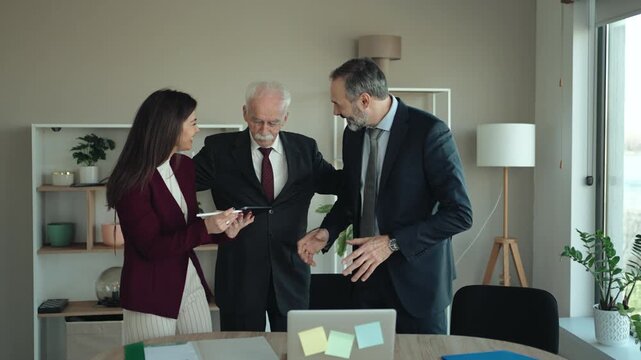 Senior Businessman with Son and Daughter in Modern Office &ndash; Family Business Transition