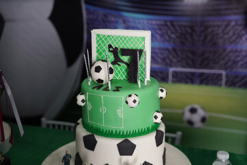 Football themed birthday cake with soccer balls, goal design, and number seven topper. Ideal for...
