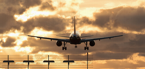 Plane landing . Silhouette of aircraft, back view. Silhouette of passenger aircraft airline on beautiful sunset background