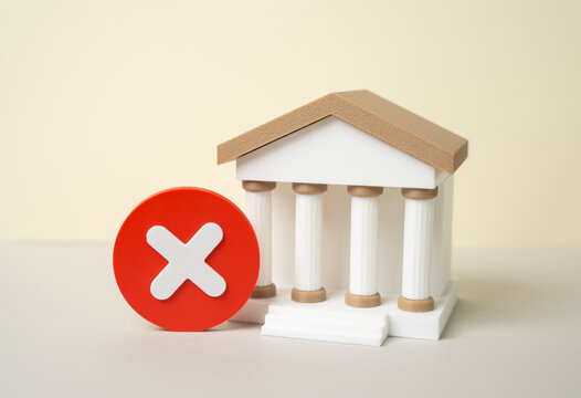 The bank building and the prohibition sign. Termination of the bank's license and the introduction of a temporary administration. Financial instability, regulatory action
