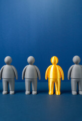 A golden figurine among the gray ones. A valuable worker, a talented collaborator. Talent recognition concept, uniqueness and high performance. Competitive advantage, motivation