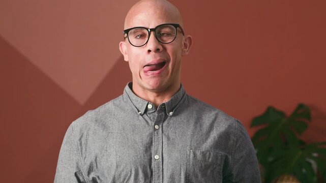 Playful Man Making Funny Faces and Sticking Out His Tongue