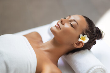 Tranquil Woman Relaxing At Spa With White Towel And Tropical Flower 