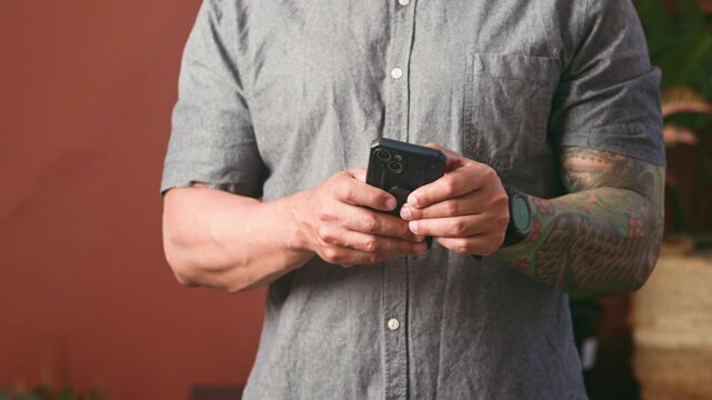 Man Using Smartphone for Digital Communication and Mobile Technology in a Casual Setting
