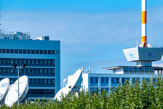 Modern building facade featuring prominent hr logo, media ARD 1 emblem, set against blue sky, European public broadcaster, German telecommunications, headquarters Hessischer Rundfunk, Frankfurt